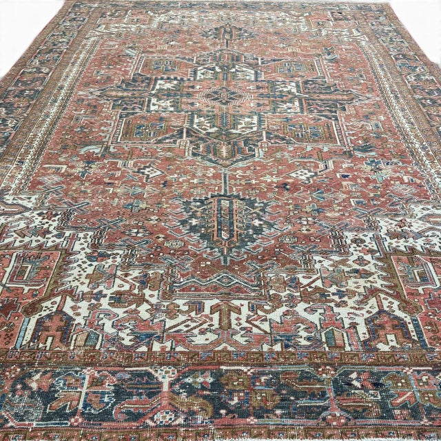 This antique Heriz rug is a timeless example of one of most iconic weaving traditions. The design is anchored by a large,...