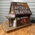 North Carolina themed birdhouse in a rustic Appalachian backwoods home style. It’s got a rusted tin roof, wood framed, and...