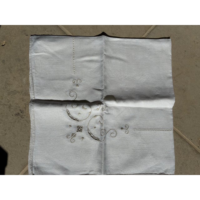 This is cream colored linen table topper. Embroidered and finished with a light gray thread with open cut work and a...