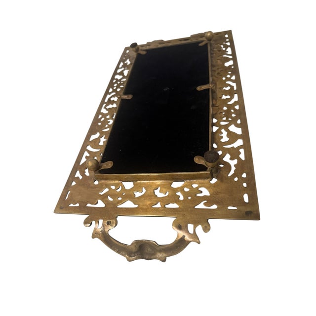 A well-cast brass-plated vanity piece in the Victorian Baroque Revival manner. The border is fully pierced and reticulated...