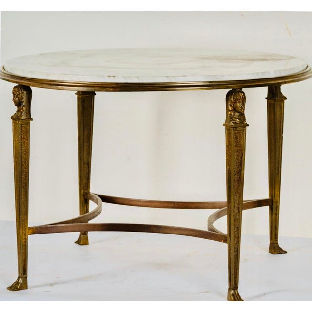 An Empire-Style Marble-Top Round Side Table raised on four monopodia Dimensions: 18 x 24 1/2 in. (45.7 x 62.2 cm.)