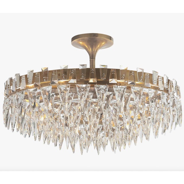 A striking Trillion flush-mount chandelier by Visual Comfort Studio, featuring a radiant arrangement of precision-cut...