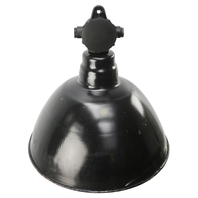 Vintage German industrial pendant light. Used in warehouses and factories in Germany. Black enamel top with Bakelite top....
