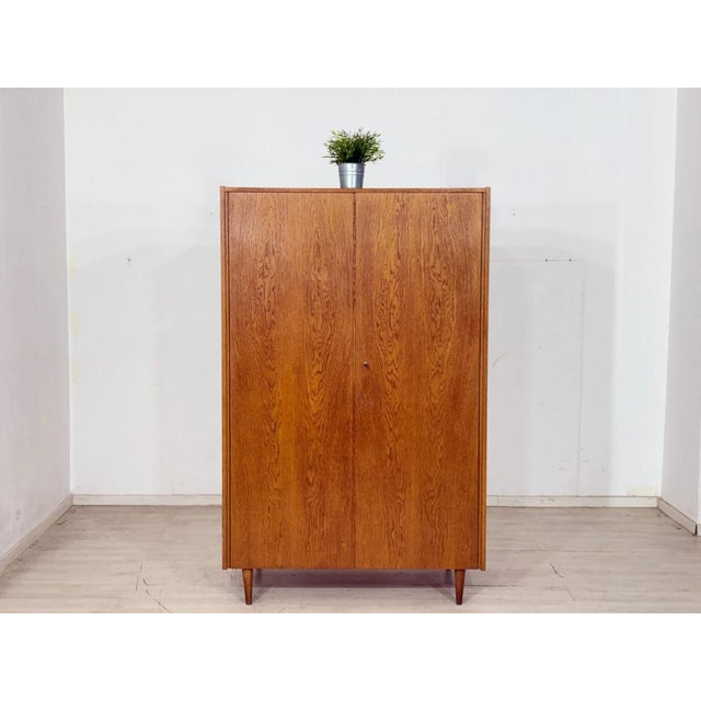 Mid-century wardrobe from the 1960s. This piece of furniture impresses with its clean lines, elegant wood grain, and...