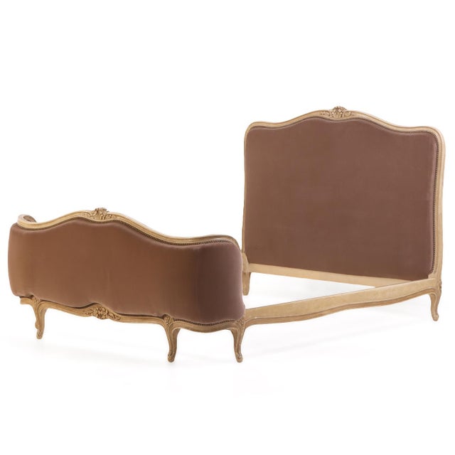 Having a gracefully shaped and molded painted wood frame with an undulating crest rail and delicate carved floral ornament...