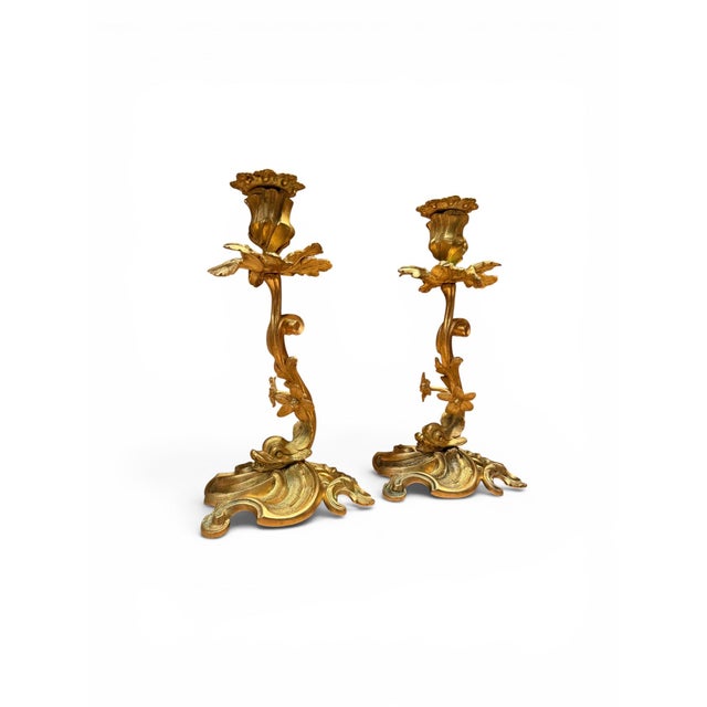 Pair of 19th century French gilt bronze candlesticks, finely chased throughout. Each features an ornate base, foliate...