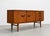 Mid Century Modern teak credenza by Beautility of England, featuring gorgeous warm teak wood grains, sculptural chunky...