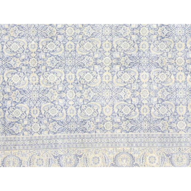 This lavish hand-knotted Persian Tabriz rug adds the perfect touch of elegance to any space. Its intricate design features...