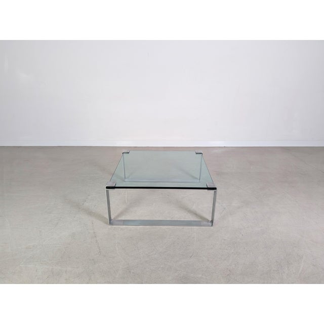 Beautiful and very well-preserved Draenert coffee table in the square version with sides approximately 93.5 cm long. The...