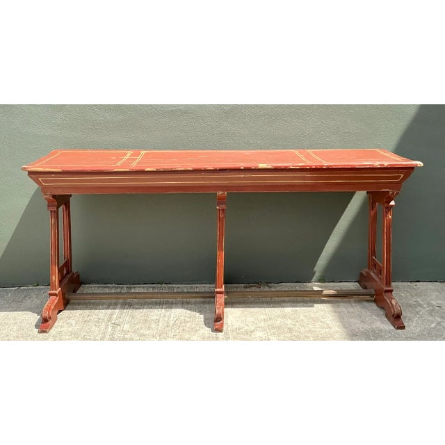 Showcasing an elongated silhouette with authentic architectural character, this vintage console table features a red...