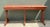 Showcasing an elongated silhouette with authentic architectural character, this vintage console table features a red...