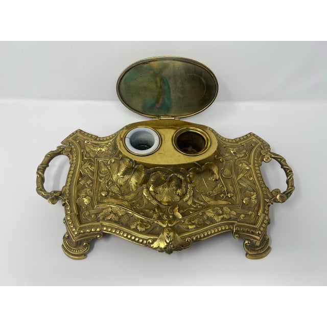 A monumental antique Victorian cast brass double inkwell dating to circa 1900. Measuring an impressive 15 inches wide,...