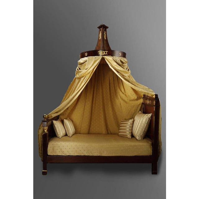 Empire period bed in solid mahogany and mahogany veneer, richly decorated with finely chased and gilded bronzes, with its...