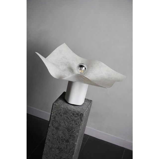 Area media table lamp by Mario Bellini for Artemide, with a rough-finished ceramic base and a parchment lampshade. This...