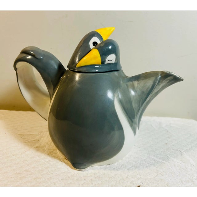 Vintage 1971 Fitz and Floyd figural penguin teapot. Features two penguins hugging. Signed and dated on the bottom.