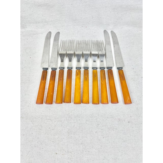 Lovely vintage set of forks and knives. Four knives and six forks. Features a wonderful butterscotch colored Bakelite...