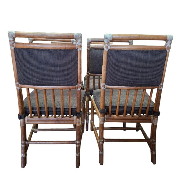Set of 4 bamboo dining side chairs ONLY by McGuire of San Francisco. Fine quality rattan with strap work bindings and...