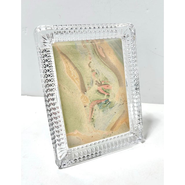A substantially heavy vintage cut crystal picture frame featuring a richly faceted diamond point border and geometric...