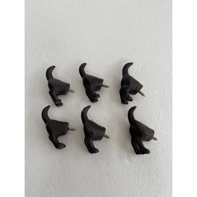 Set of 6 whimsical cast iron rear end dog hooks in a dark brown finish. Screw into any surface or mount on a board to use...