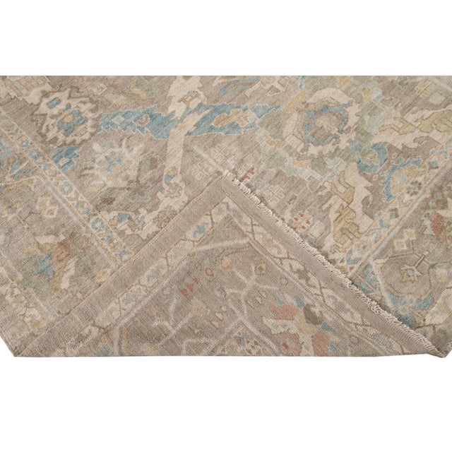 Beautiful modern Sultanabad hand knotted wool rug with a beige field. This Sultanabad rug has a blue, brown, and ivory...