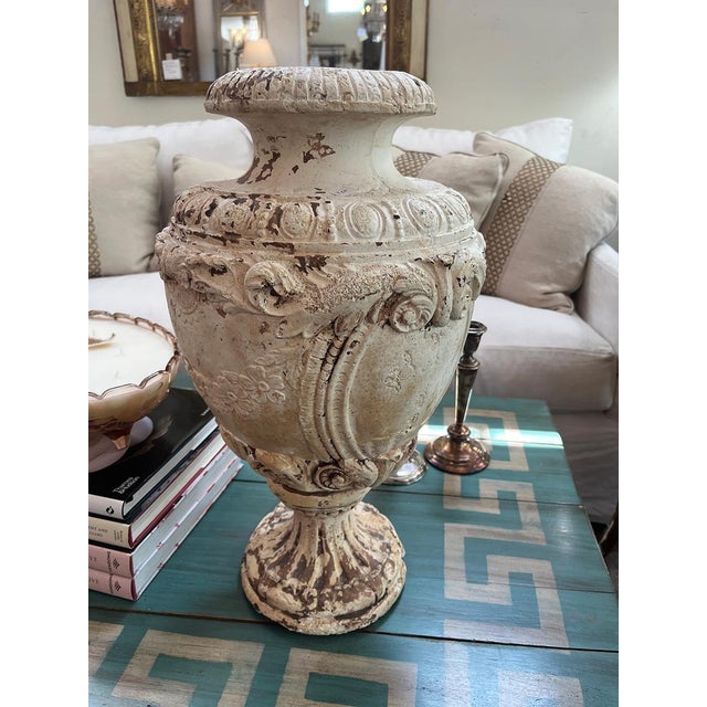 This plaster cast urn is full of stunning details. There is some chipping, consistent with the piece's age, adding to its...