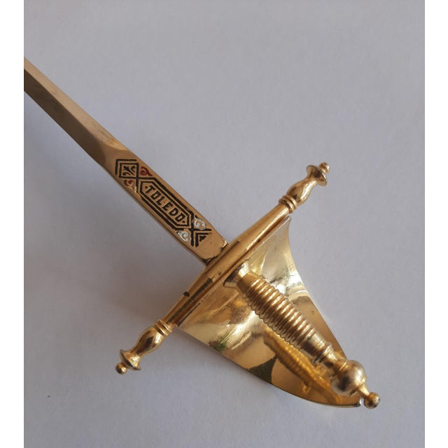 Spanish Sword Letter Opener A stunning Spanish sword letter opener, elegantly finished in a gold tone and proudly branded...