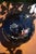 Elegant antique black glass casket box decorated with a finely detailed peacock surrounded by colorful floral and foliate...