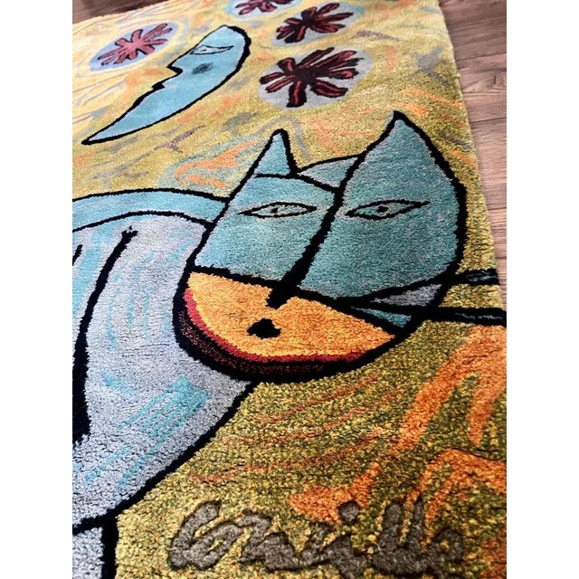 This tapestry featuring the motif "Le chat la lune et le soleil" by Corneille Guillaume van Beverloo appears to be a very...