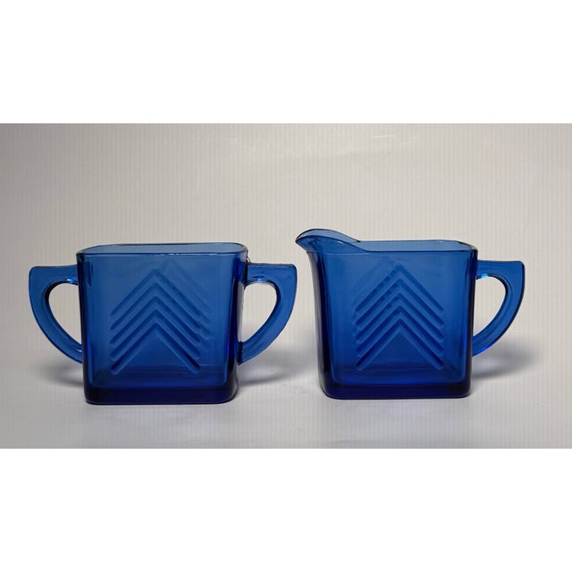 A chevron, Art Deco motif is etched on this set of rich cobalt blue sugar and creamer set. Made of depression glass by...