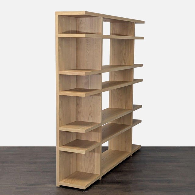 This West Elm bookshelf features a clean, modern look with a natural wood finish. The open shelving design provides plenty...