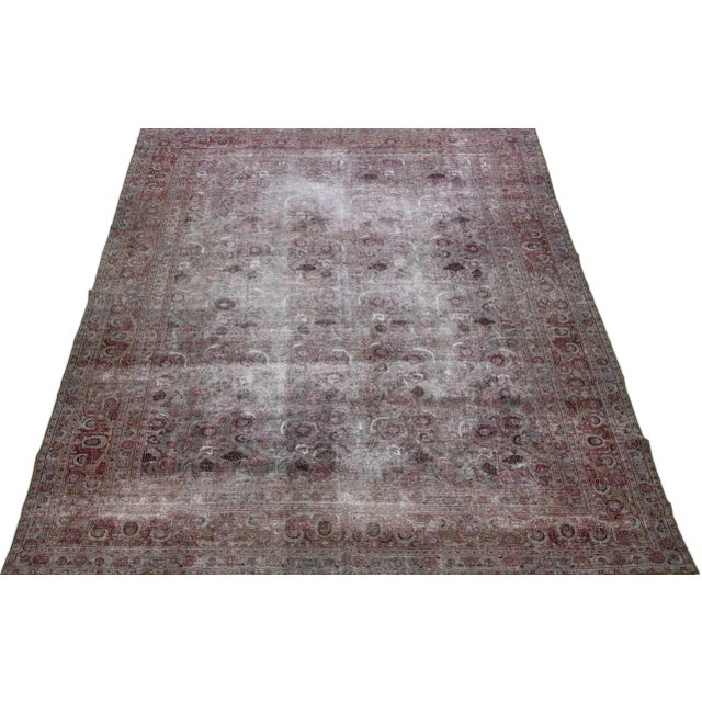 Beautiful antique Persian distressed Tabriz hand-knotted wool rug with a gray color field. This piece has a rusted frame...