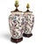 A striking pair of vintage ceramic urn or ginger jar table lamps featuring an exuberant allover botanical and butterfly...
