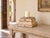 This square column base steps outward in three tiers, wide at the foot and narrowing as it rises, and the paint tells its...
