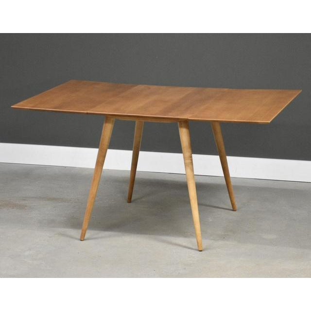 A mid century modern maple dining table designed by Paul McCobb for Winchendon’s Planner Group. Professionally refinished....