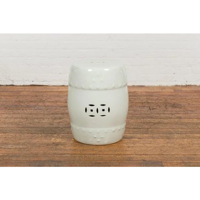A Chinese vintage blanc de Chine ceramic garden stool from the mid 20th century, with pierced and raised motifs. Created...