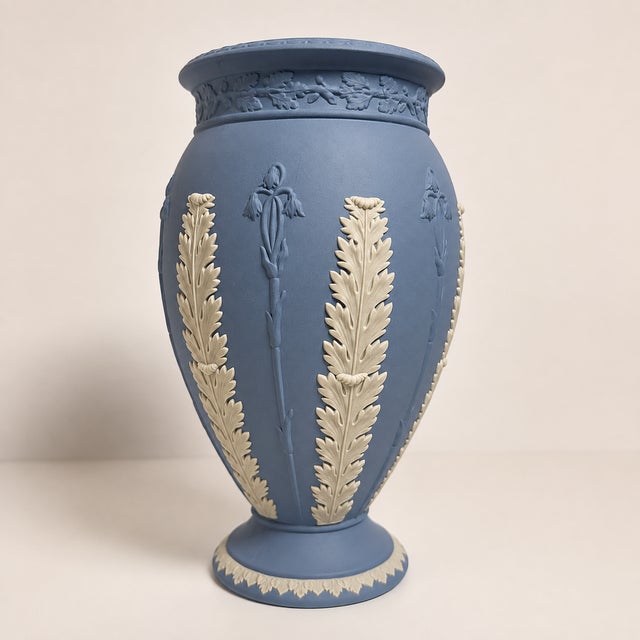 Vintage Wedgwood jasperware vase in the classic matte blue finish, decorated with applied white acanthus leaves and...