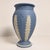 Vintage Wedgwood jasperware vase in the classic matte blue finish, decorated with applied white acanthus leaves and...