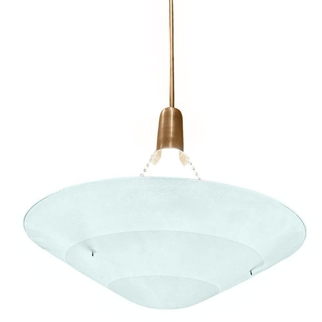 Late 1980s Streamlined inspired Memphis sky art blue glass pendant chandelier with glass. Features a beautifully...