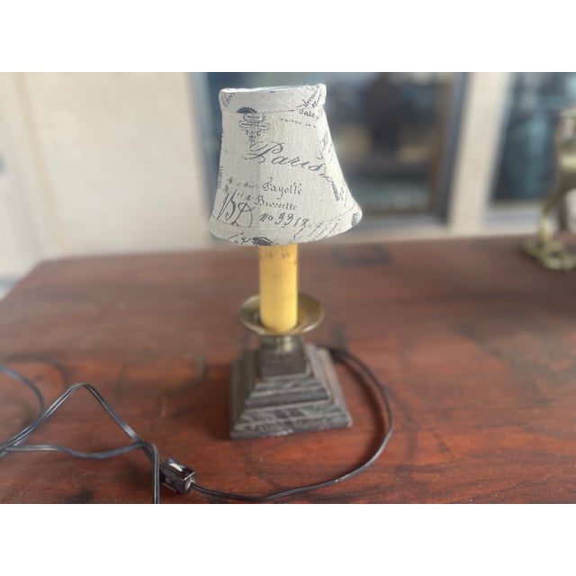 This lamp is a vintage (1940's)-style accent lamp featuring a dark period wood base and a "Paris Letters" postcard-printed...