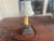 This lamp is a vintage (1940's)-style accent lamp featuring a dark period wood base and a "Paris Letters" postcard-printed...
