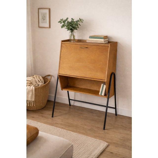 Charming vintage secretary desk dating from the 1960s, with a clean design and elegant lines. Its light wood cabinet...