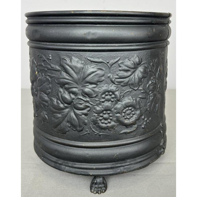 A decorative Vintage French painted brass pot , featuring a dark painted finish with prominent raised floral decoration...
