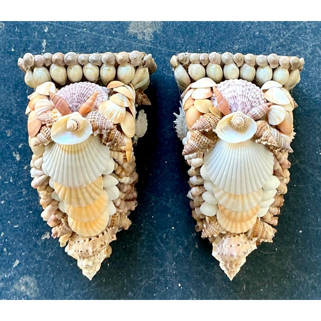 This exquisite pair of vintage wall brackets is a masterful celebration of coastal artisanal craft and "Shell Grotto"...