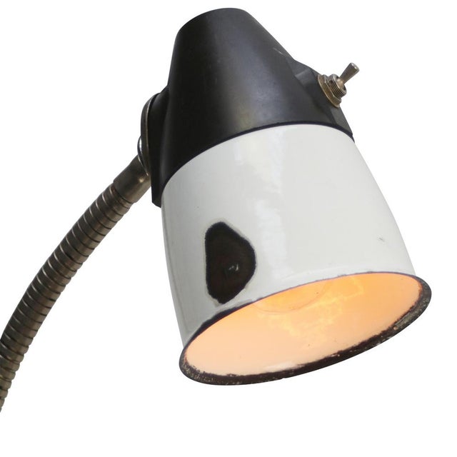Metal work light with flexible gooseneck arm. White enamel shade with Bakelite top Switch in shade. Available with UK / US...