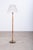Elegant Danish floor lamp from the 1960s, combining warm teak with refined brass detailing. The original shade is...