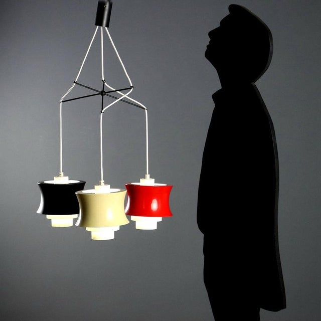Vintage three-light ceiling lamp with white, red, and black lacquered metal lampshades. This piece is attributed to the...