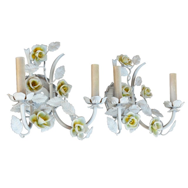 A charming pair of wall sconces in metal, adorned with handcrafted ceramic flowers in pale yellow & white. Hardwired for...