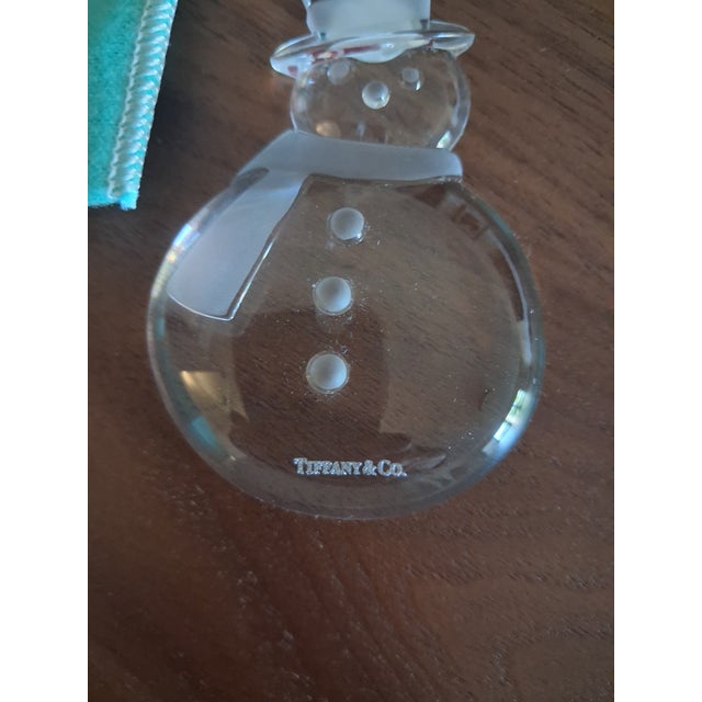 Tiffany & Co. Crystal Snowman Ornament in brand-new condition, complete with its original Tiffany Blue box and fabric...