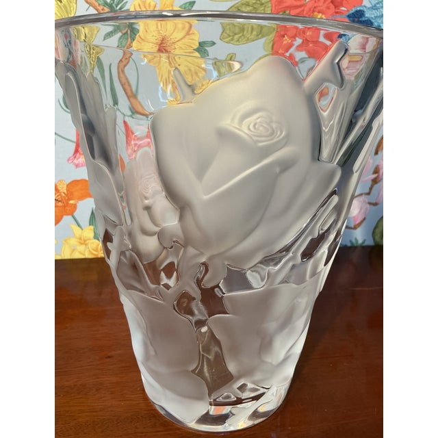Elegant Lalique crystal vase featuring a delicate rose motif, showcasing the brand’s signature craftsmanship and timeless...
