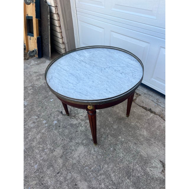 Elegant French Louis XVI side table crafted in walnut with a beautifully figured veneer. It features a single drawer, a...